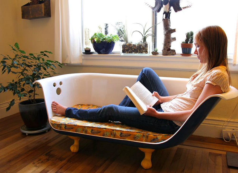 woman reading on chase lounge repurposed from an old bath